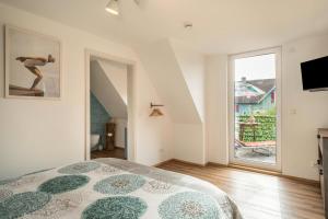 a bedroom with a bed and a large window at Seekind in Kressbronn am Bodensee