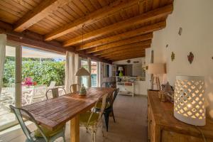 a kitchen and dining room with a wooden table and chairs at Casa degli Stecchi in Capoliveri