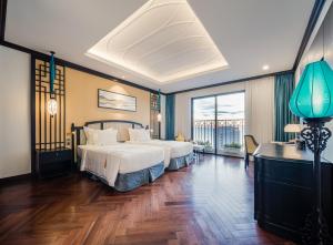 a bedroom with a large bed and a large window at Potique Hotel in Nha Trang