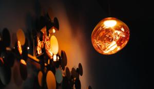 a group of lights hanging from a wall at The Rokxy Townhouse - Kings Cross in London