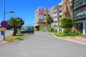 a car driving down a street in a building at Soleil & Piscine BOUZNIKA in Bouznika