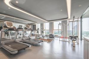 a gym with cardio equipment and a large window at Atour Hotel Nantong Central South BRICS in Nantong