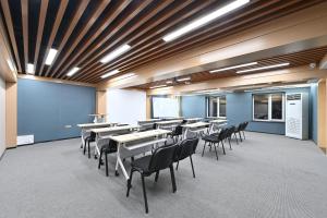 a classroom with tables and chairs in a room at Atour X Hotel Zhongshan Road Shenyang Station in Shenyang