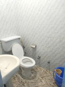 a bathroom with a white toilet and a sink at Dylan Cafe And Guest House in Jodhpur +55 photos
