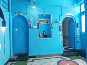 a blue building with a sign that reads restart at Dylan Cafe And Guest House in Jodhpur