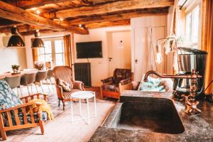 a living room with a couch and a table at CRASH'NSTAY - 't Silo Huis in Sprang-Capelle