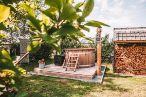 una terraza de madera con una silla en un patio en CRASH'NSTAY - 't Silo Huis, en Sprang-Capelle