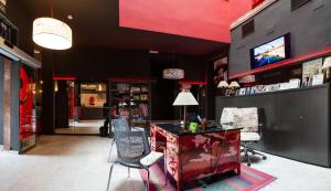 a store with chairs and a desk and a television at Ritual Alameda Sevilla in Seville