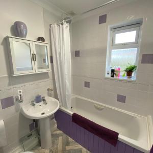 a bathroom with a sink and a toilet and a tub and a sink at Agapanthus Bed & Breakfast - Fraddam in Hayle