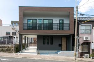 a building with a balcony on the side of it at VILLA Sasebo Stad #SS1 in Sasebo
