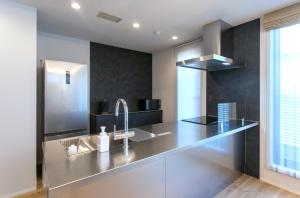 a kitchen with a stainless steel counter with a sink at VILLA Sasebo Stad #SS1 in Sasebo