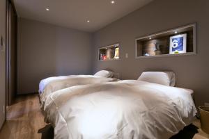 a room with two beds in a room with a sign on the wall at VILLA Sasebo Stad #SS1 in Sasebo