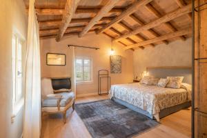 a bedroom with a bed and a chair at Agriturismo Monte Bisson in Soave