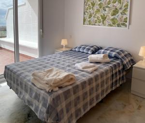 Un dormitorio con una cama con dos toallas encima. en Résidence Bahia Golf, en Mutxamel 11 fotos más