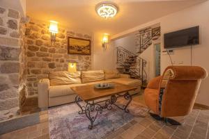 a living room with a couch and a table at Waterfront Villa in Muo in Kotor