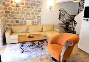 a living room with a couch and a table at Waterfront Villa in Muo in Kotor