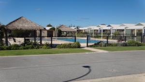 a street with a fence and some houses at Unit 24 Seafront Estate in Jurien Bay
