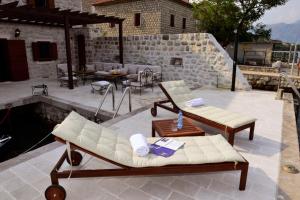 a patio with couches and a table at Waterfront Villa in Muo in Kotor