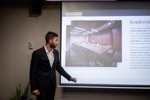 a man in a suit is giving a presentation at Amsterdam Hotel in Belgrade