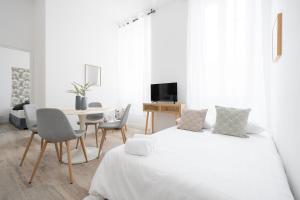biały pokój z 2 łóżkami i stołem w obiekcie Le Complexe Concorde - 3 Apartments 16 pers Vélodrome Terrasse Clim w Marsylii