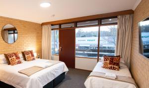 a hotel room with two beds and a window at Bentley's Hotel in Clare