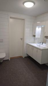 a bathroom with a toilet and a sink and a mirror at Hillegård in Lærdalsøyri