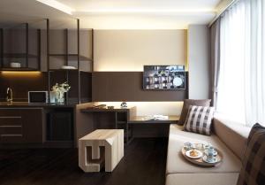 a living room with a couch and a table at Happy 3 in Bangkok