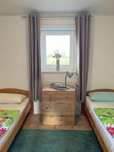 a room with two beds and a desk with a window at "Haus am Meer"Fewo 2 - a71226 in Butjadingen