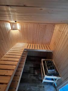 an inside view of a sauna with a wooden ceiling at Ferienhaus Kompass (ehemals Pension Hohlen) in Carolinensiel