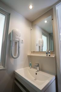 a bathroom with a sink and a mirror at Happy Camp mobile homes in Camping Village La Masseria in Gallipoli