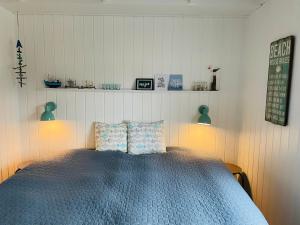 a bedroom with a bed with two pillows on it at Harbour Living in Hvide Sande
