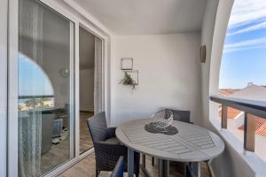 a small table and chairs in a room with a balcony at Park Santiago 2 Luxury Studio 8 in Arona