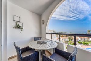 a balcony with a table and chairs and a window at Park Santiago 2 Luxury Studio 8 in Arona