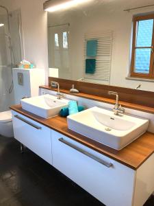 a bathroom with two sinks and a large mirror at Appartement Linde in Mürzzuschlag