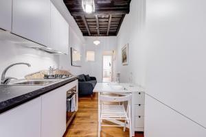 a kitchen with white cabinets and a counter top at Boschetto 118 in Rome