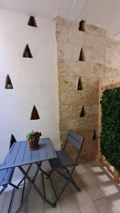 a blue table and a chair in a room at LITHOS ROOMs in Matera +77 photos