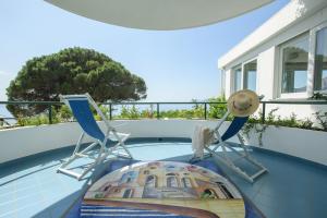 two chairs and a table on a swimming pool at Hotel Il Pino in Praiano