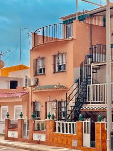 un edificio con una escalera en el lateral en Fantastic NEW 120m2 Beach House in El Palo Malaga, en Málaga