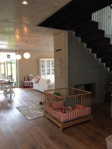 a room with a staircase and a living room with a crib at Ferien- und Seminarhaus Seeger in Haunsheim