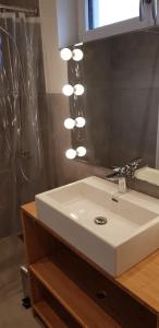a bathroom with a white sink and a mirror at Mecklenburgische Seenplatte - Saniertes und gemütliches Ferienhaus mit großem Garten und Steg in Großzerlang