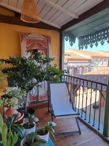 a blue chair sitting on a balcony with plants at La Loggia - chambres d'hôtes in Rieux