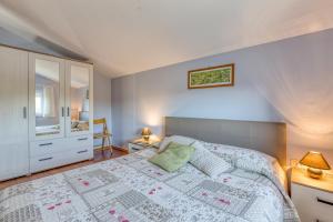 a bedroom with a bed and a dresser and a mirror at Casa Olivia in Kaštelir +42 photos