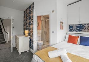 a bedroom with a king sized bed and a shower at The Narrow House - Free Parking By My Getaways in Brighton & Hove
