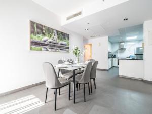 a dining room with a table and chairs at Luxury Waterfront Apartment with Beach Access in Dubai