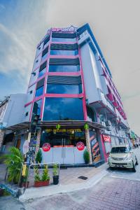 um edifício com um carro estacionado em frente em SP Star Hotel em Sungai Petani