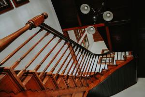 a wooden spiral staircase in a house at Swartvlei Guest Farm in Sedgefield