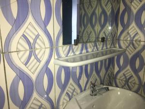 a bathroom with a sink and a mirror at Residence MaryHouse - Free Breakfast and Taxi From Airport in Cotonou +82 photos