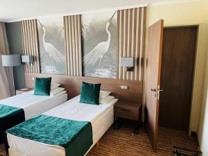 A bed or beds in a room at Thermal Hotel Visegrád