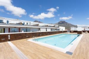 a large swimming pool on the side of a building at River Suite El Galeón in Adeje