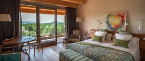 a hotel room with a bed and a balcony at La Garriga de Castelladral in Castelladral